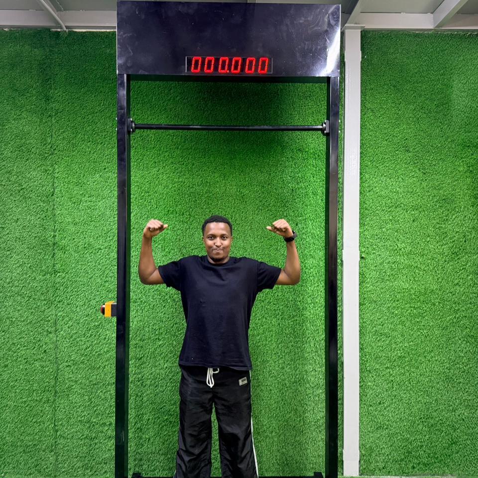 Viral 100-Second Hanging Challenge arcade machine rental for corporate events in Dubai, featuring a digital timer and participants testing their grip strength.